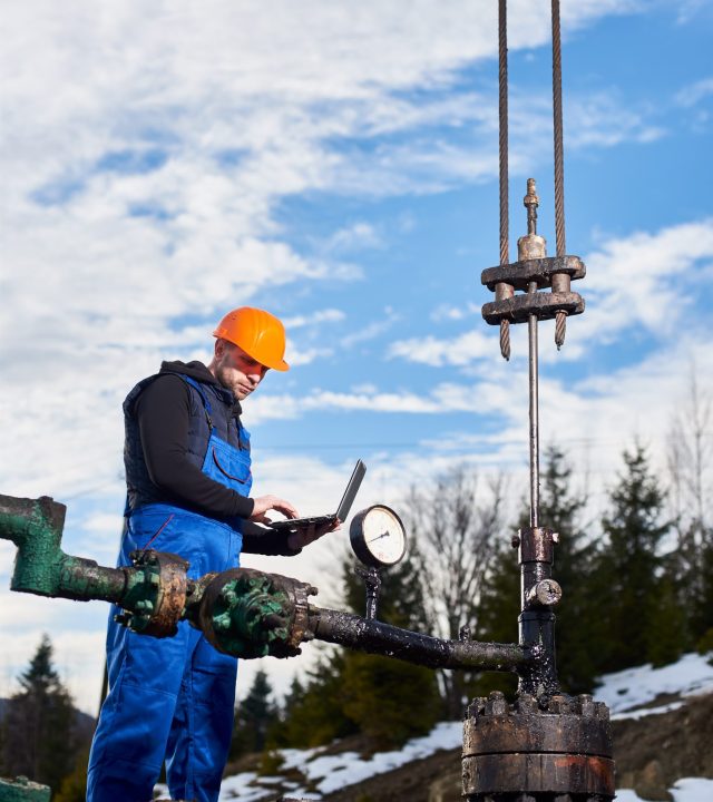 petroleum-engineer-using-laptop-oil-field (1) specialization dajaq ltd
